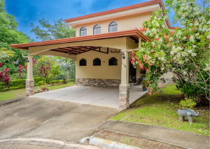 Covered terrace surrounded by greenery at a home for sale in Grecia, Costa Rica